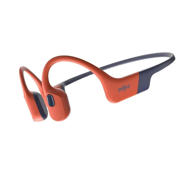 Orange and black wireless earbuds on a white background
